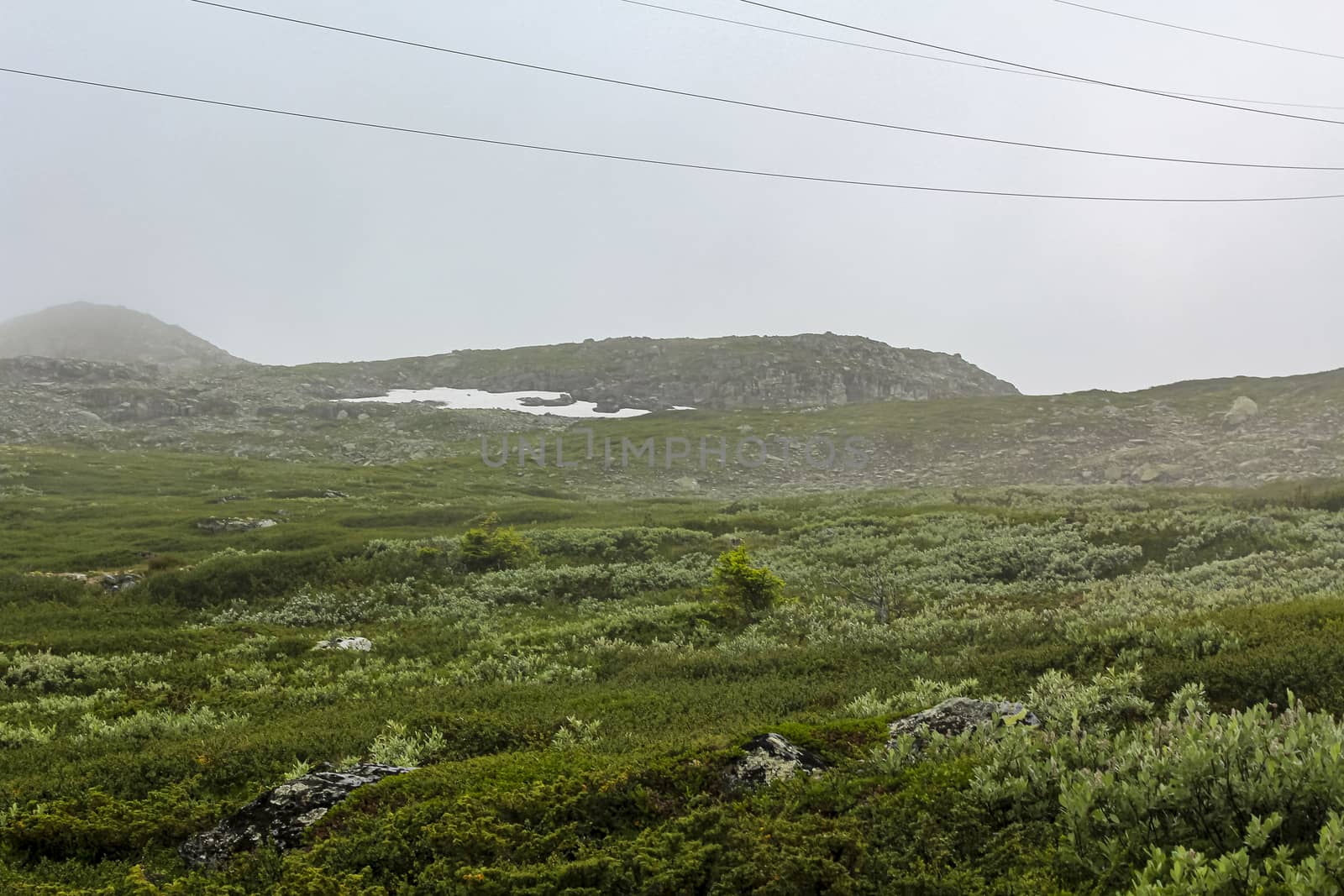 Fog, clouds, rocks and cliffs on Veslehødn Veslehorn mountain in Hemsedal, Norway.