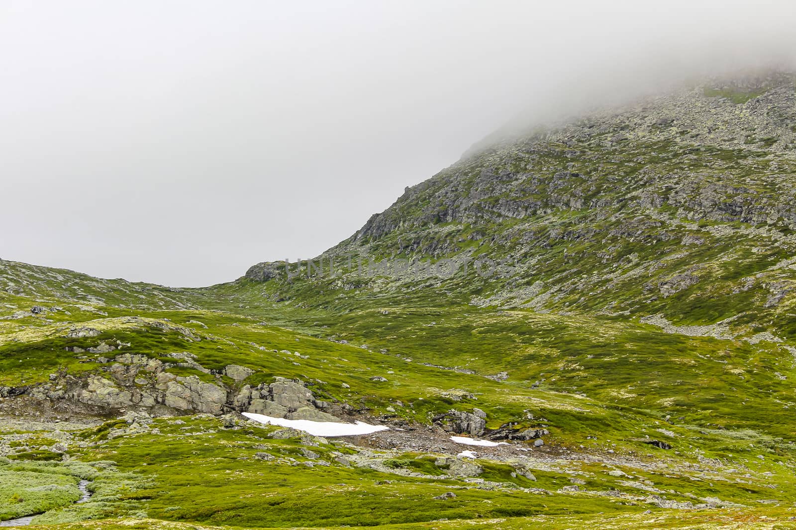 Fog, clouds, rocks and cliffs on Veslehødn Veslehorn mountain in Hemsedal, Norway.