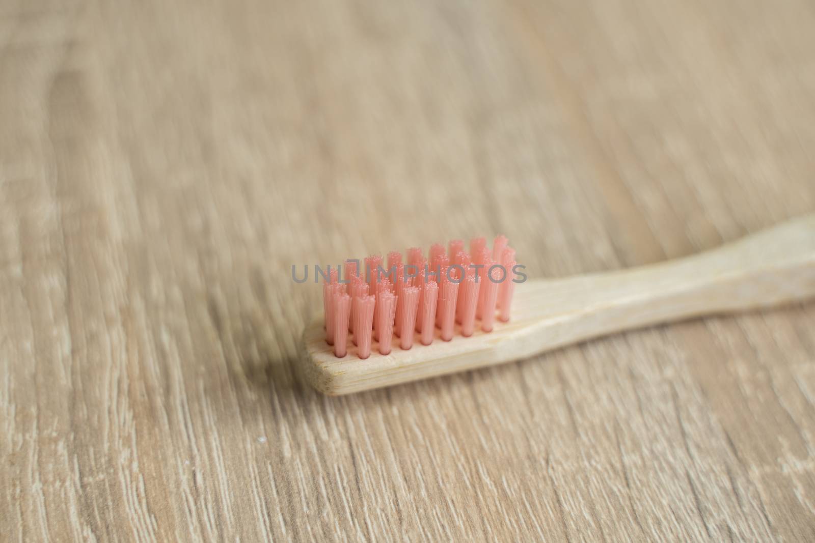 Eco-friendly bamboo toothbrush on a table. Zero-waste. Biodegradable toothbrush. by vovsht