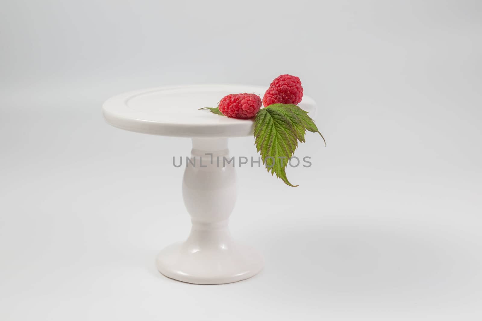 Red ripe Raspberry on white background.
