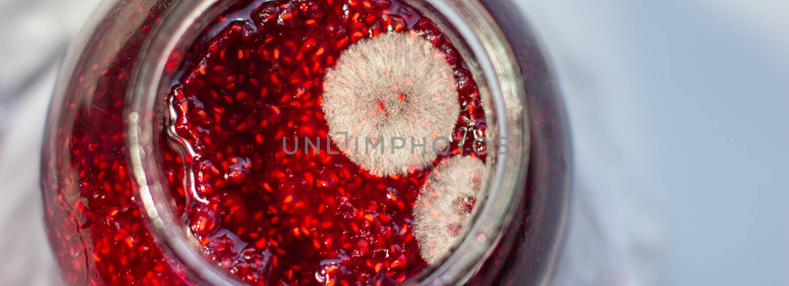 Mold in a jar of raspberry jam. Hazardous to health.  by AnatoliiFoto