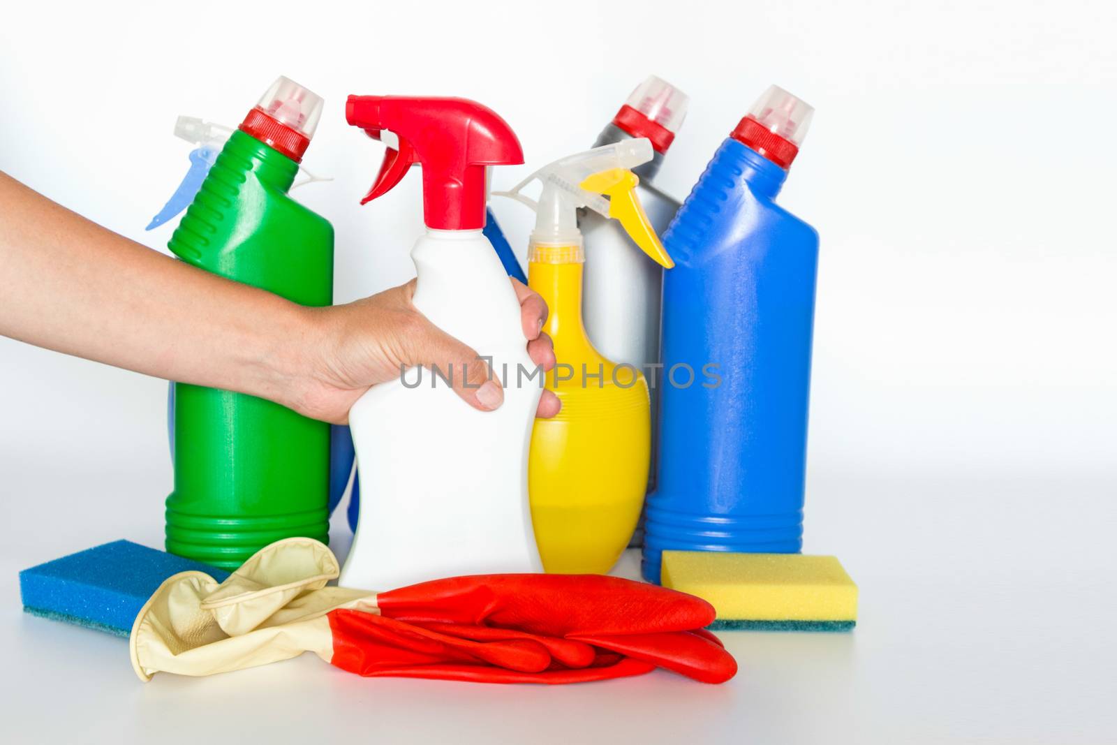 Hand with Plastic bottles with chemicals for home cleaning by galinasharapova