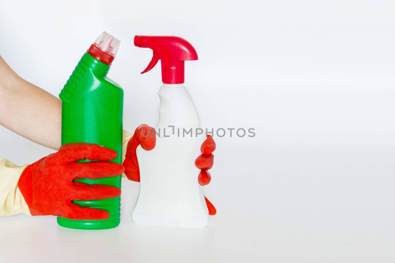 Hand with Plastic bottles with chemicals for home cleaning by galinasharapova
