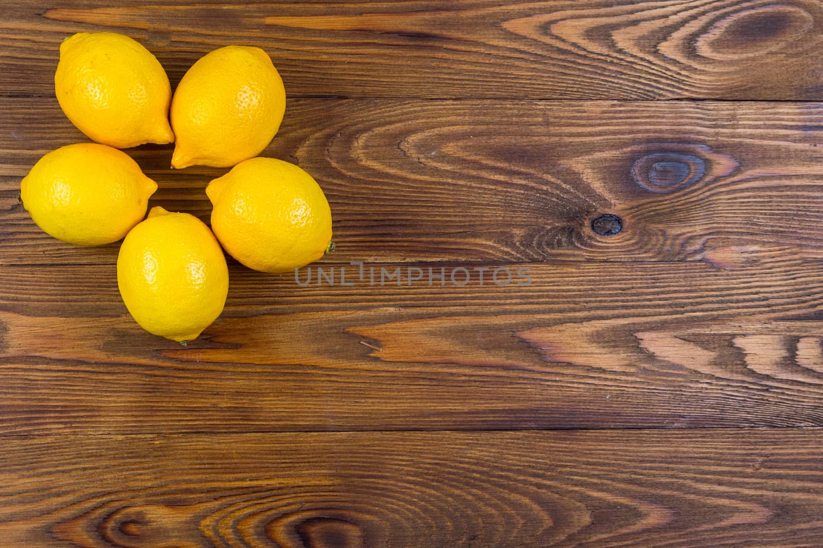 High Angle Still Life View of lemons on Rustic Wood Table.