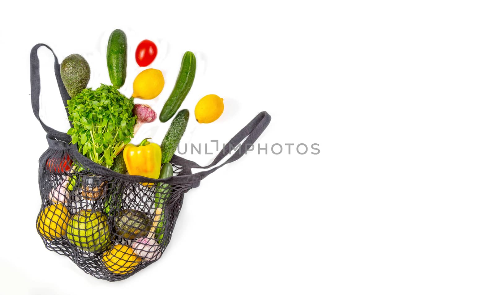 Shopping bag with assortment of fresh vegetables on white background