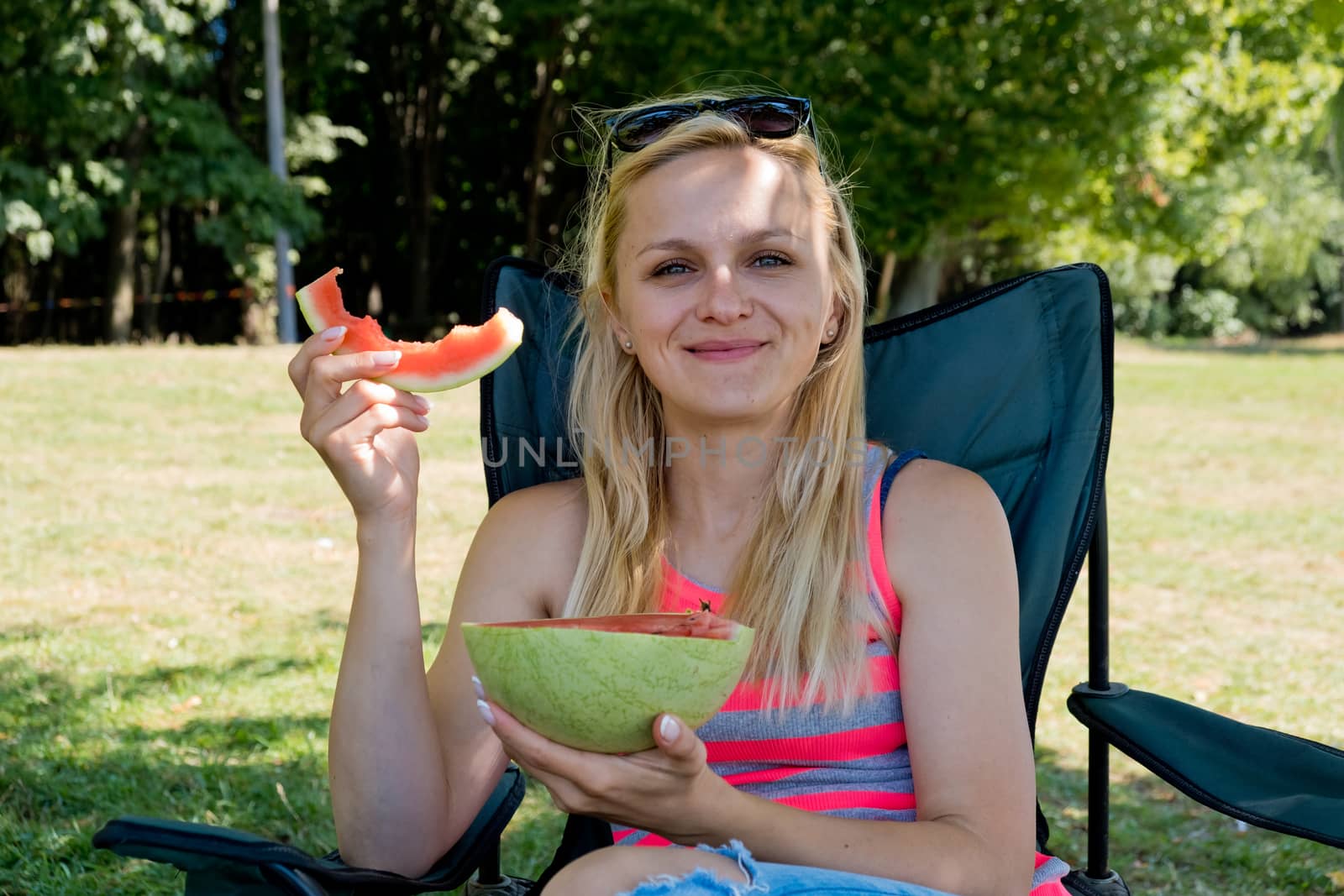 Young woman eating watermelon. Close-up.