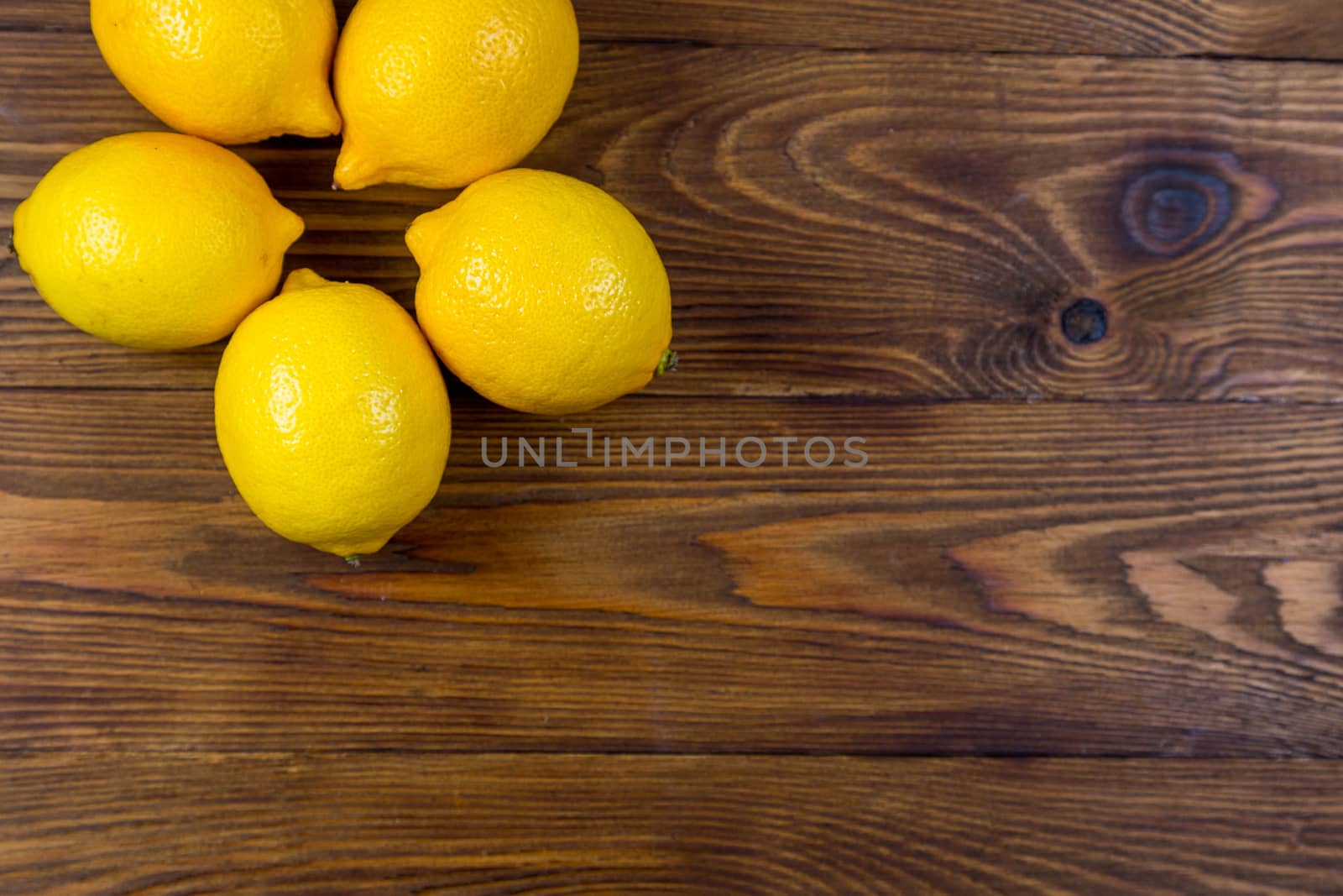 High Angle Still Life View of lemons on Rustic Wood Table.