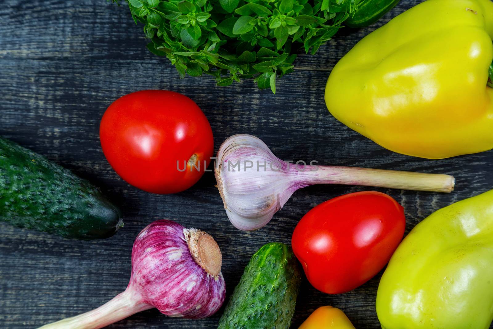 Pepper, garlic, tomato, cucumber, basil on a cutting board by galinasharapova