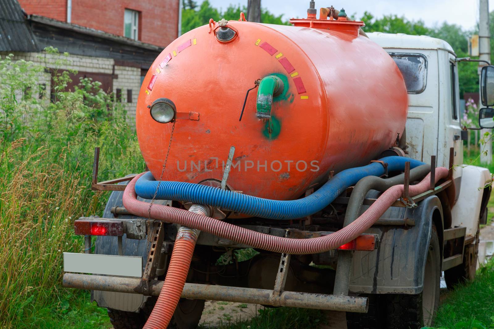 A Sewage truck working in village environment by galinasharapova