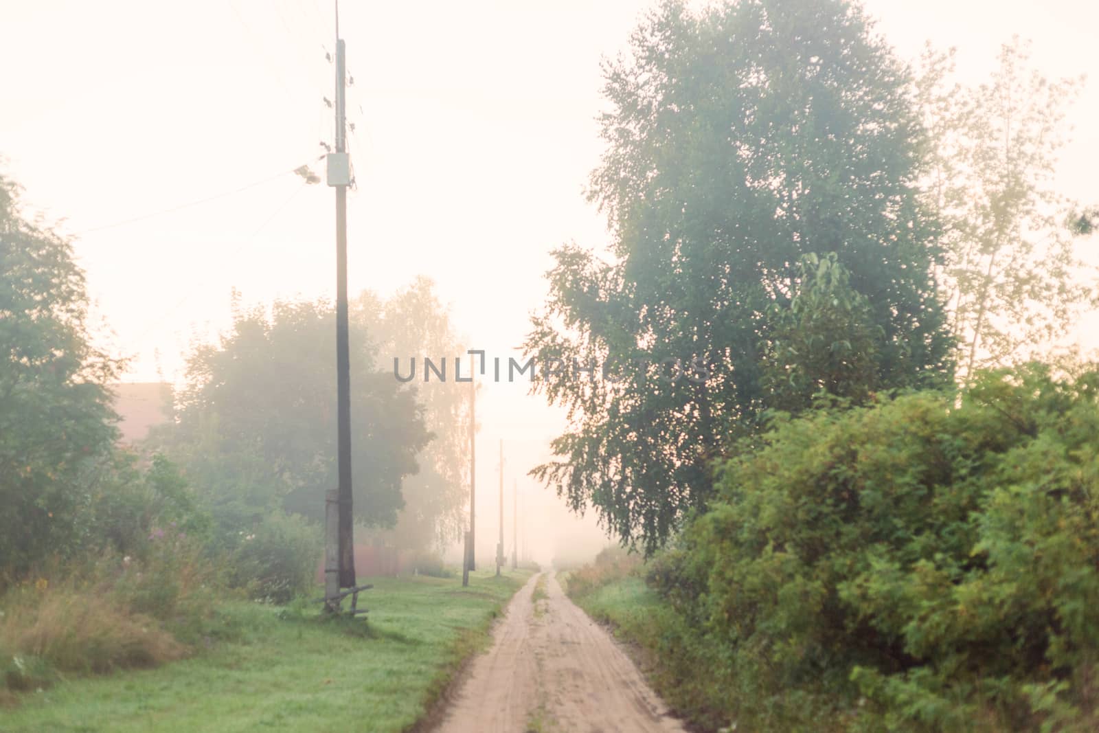 Rural landscape on a early foggy morning in the village. by galinasharapova