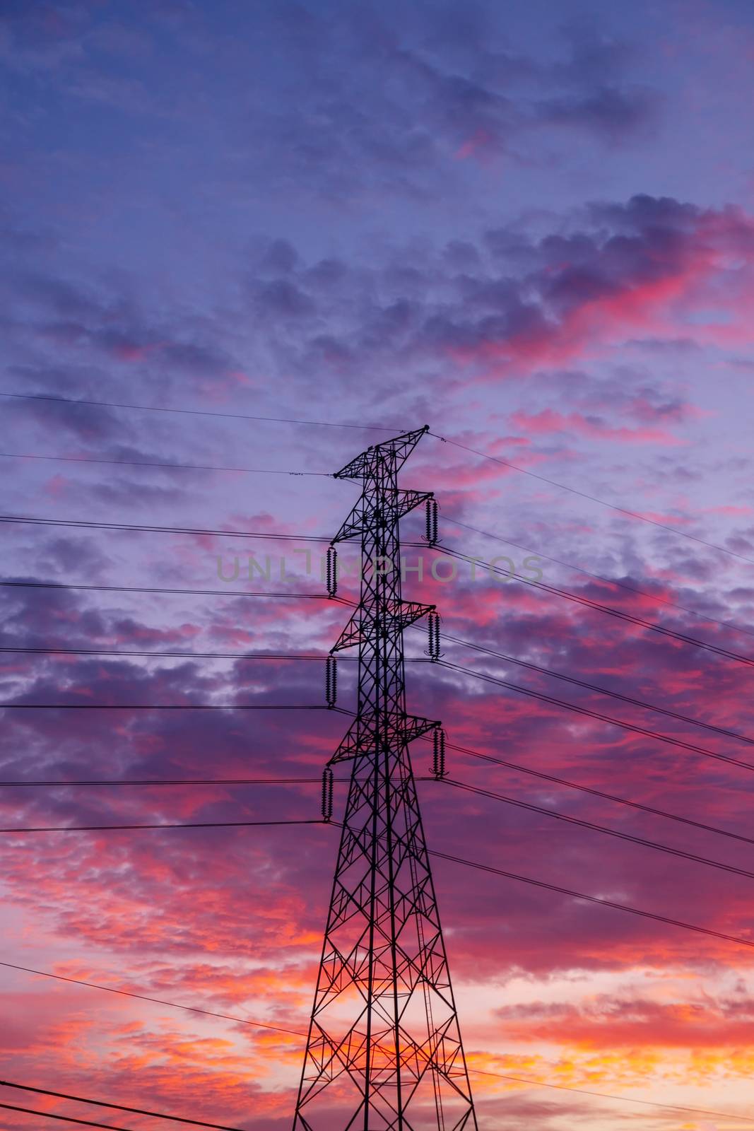 High voltage electricity pylon pole with sky and cloud colorful sunset background, Monochromatic tone, Dramatic cloud sky