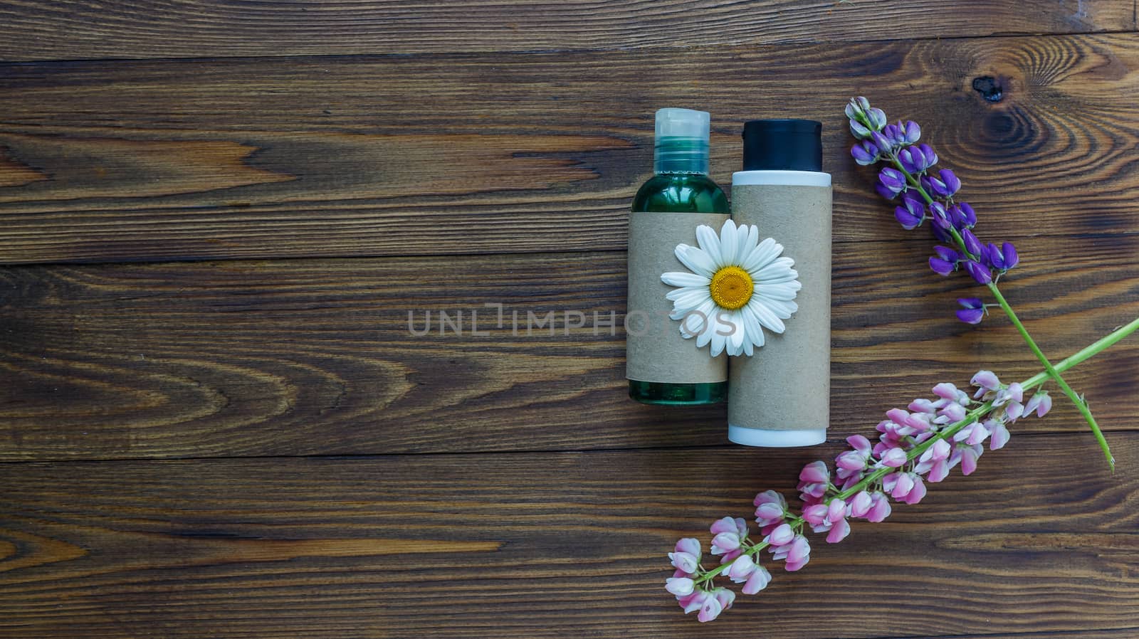 Cosmetic bottle containers with hermal camomile flowers Blank label for branding mock-up, Natural organic beauty product concept. Handmade, freshness.