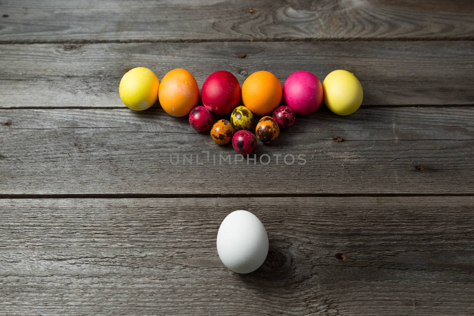 Hand painted easter eggs arranged like for billiards on wooden background. by galinasharapova