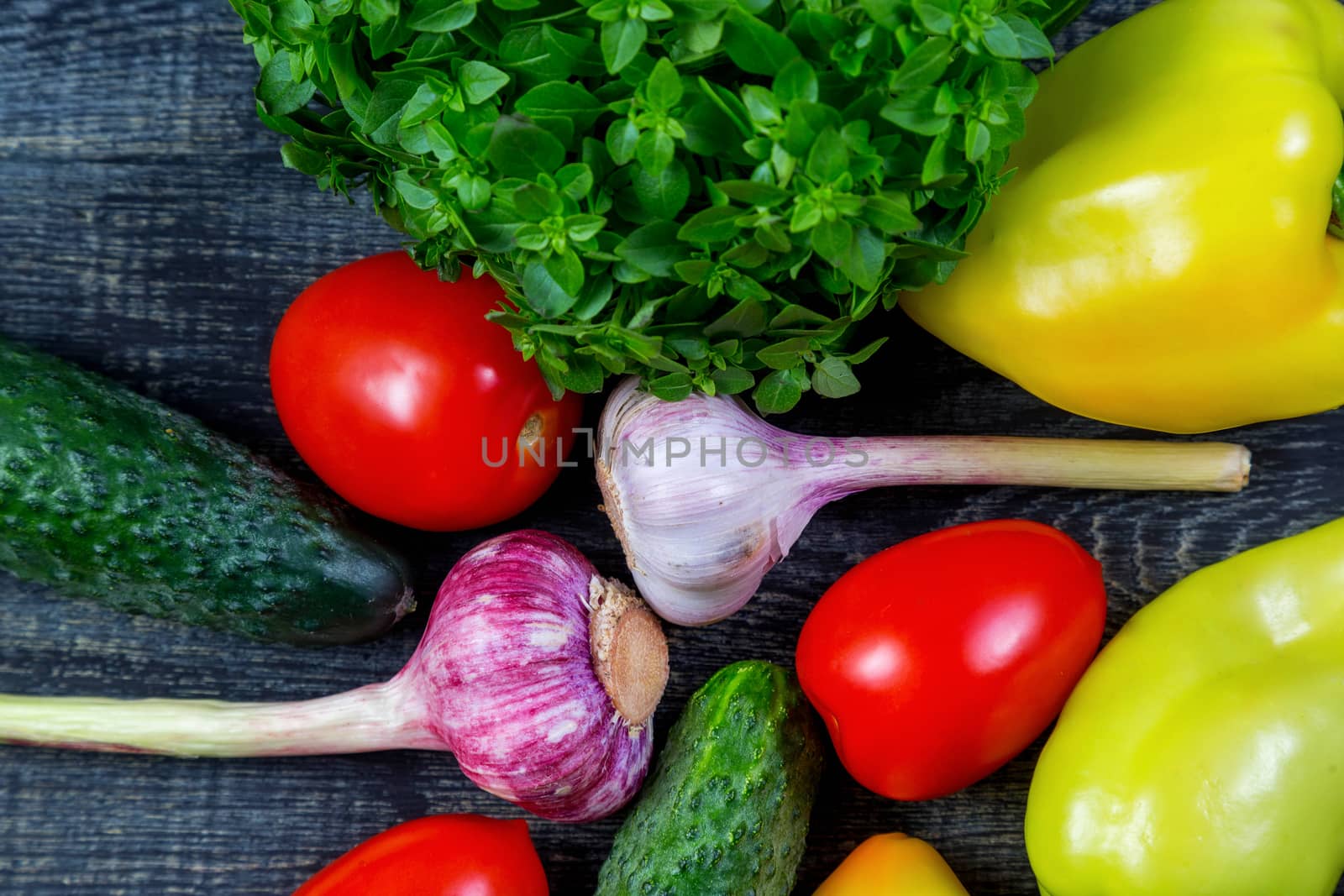 Pepper, garlic, tomato, cucumber, basil on a cutting board by galinasharapova