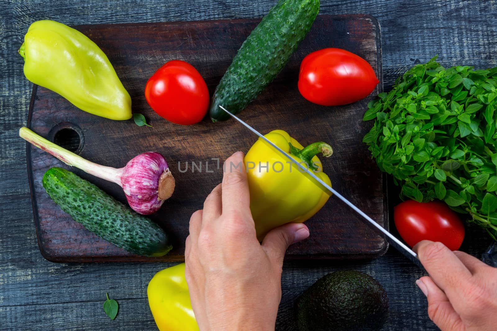 Closeup image of a woman cutting and chopping bell pepper by galinasharapova