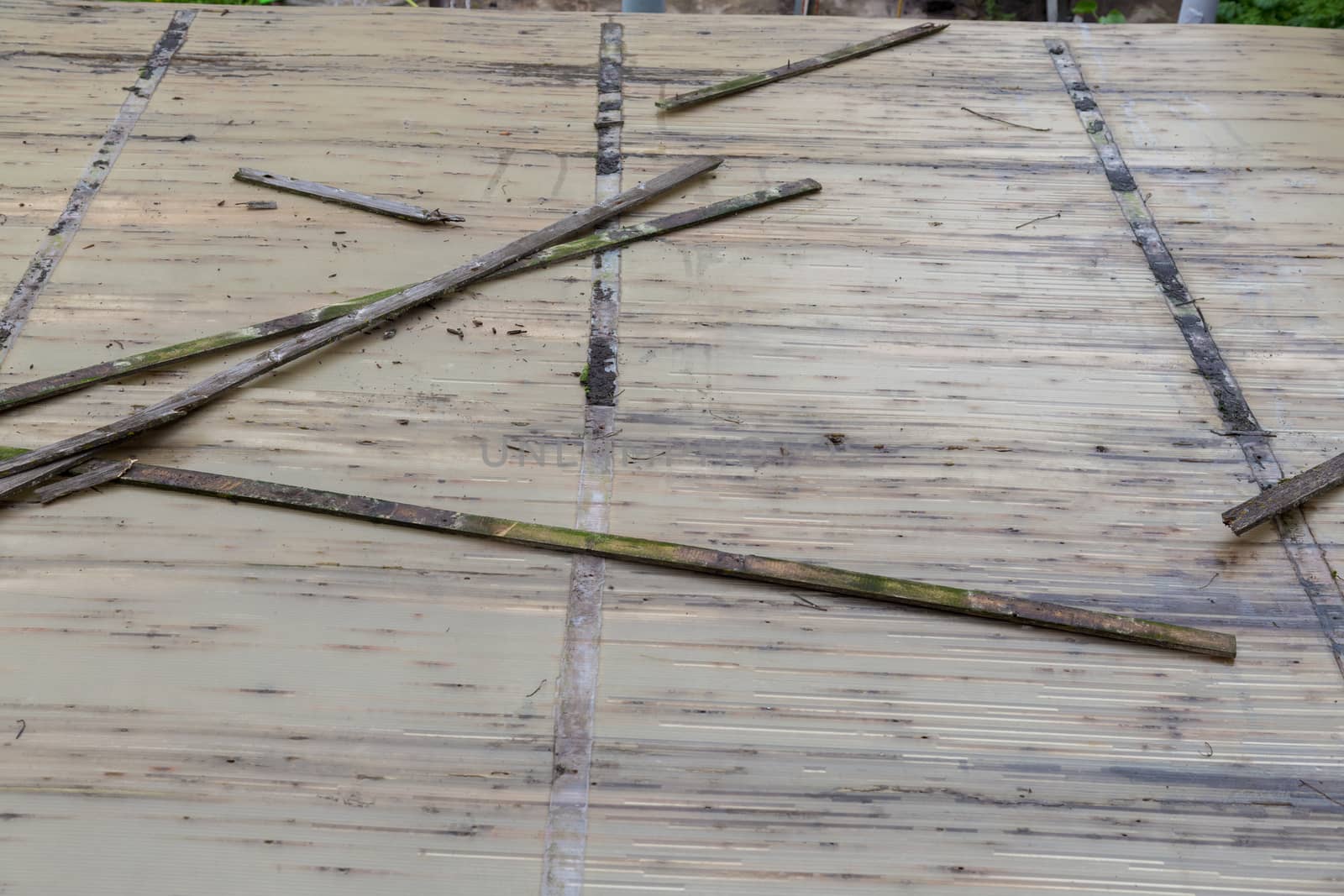 Dismantling Old corrugated polycarbonate roof on the village house.