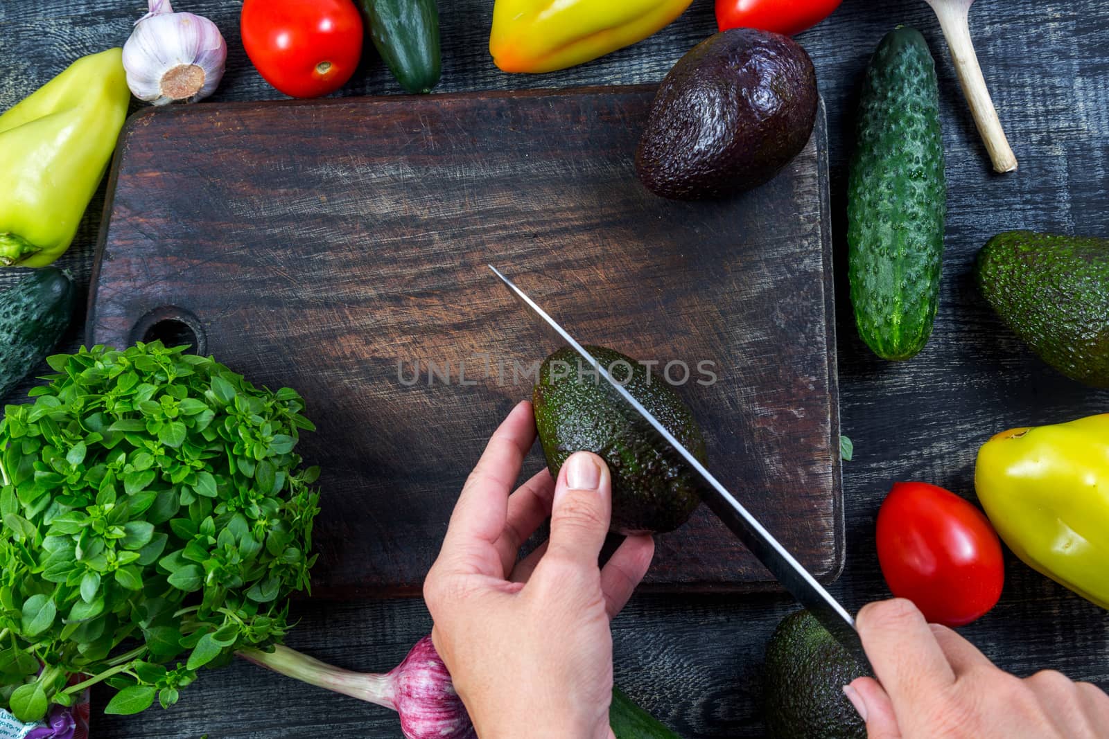 Closeup image of a woman cutting and chopping avocado by galinasharapova