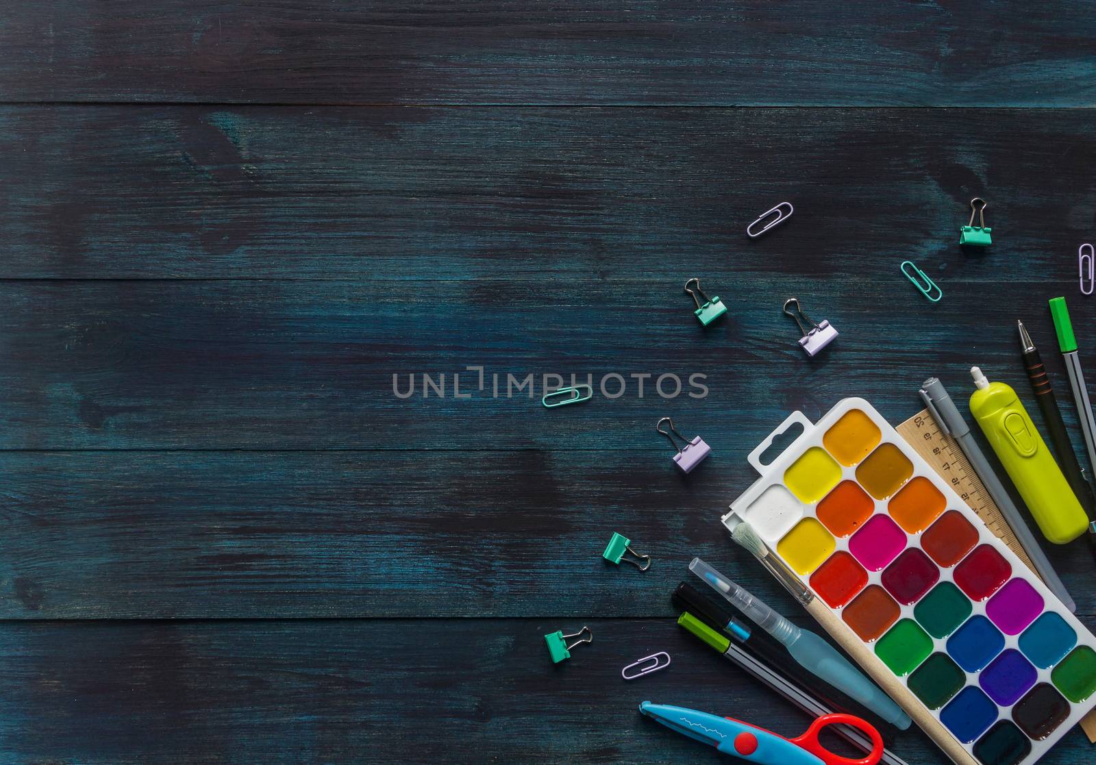 School supplies with medical face mask on a wooden background. Top view by galinasharapova