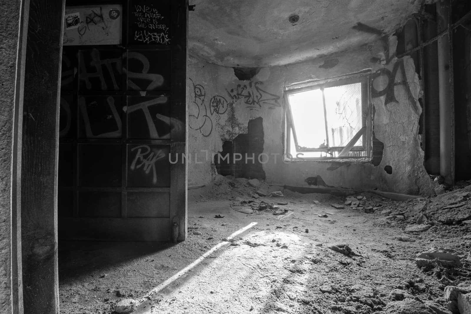 An Old Window in an Abandoned Building Full of Dust and Debris With Lights Shining Through