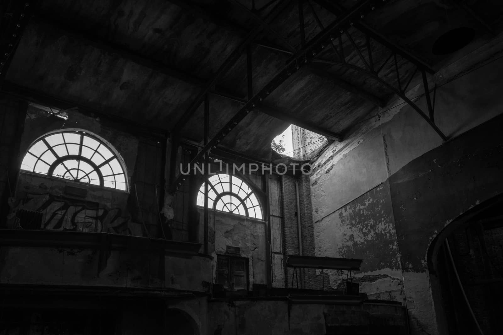 Two Large Windows in an Abandoned Theatre Letting Light Shine Into the Room