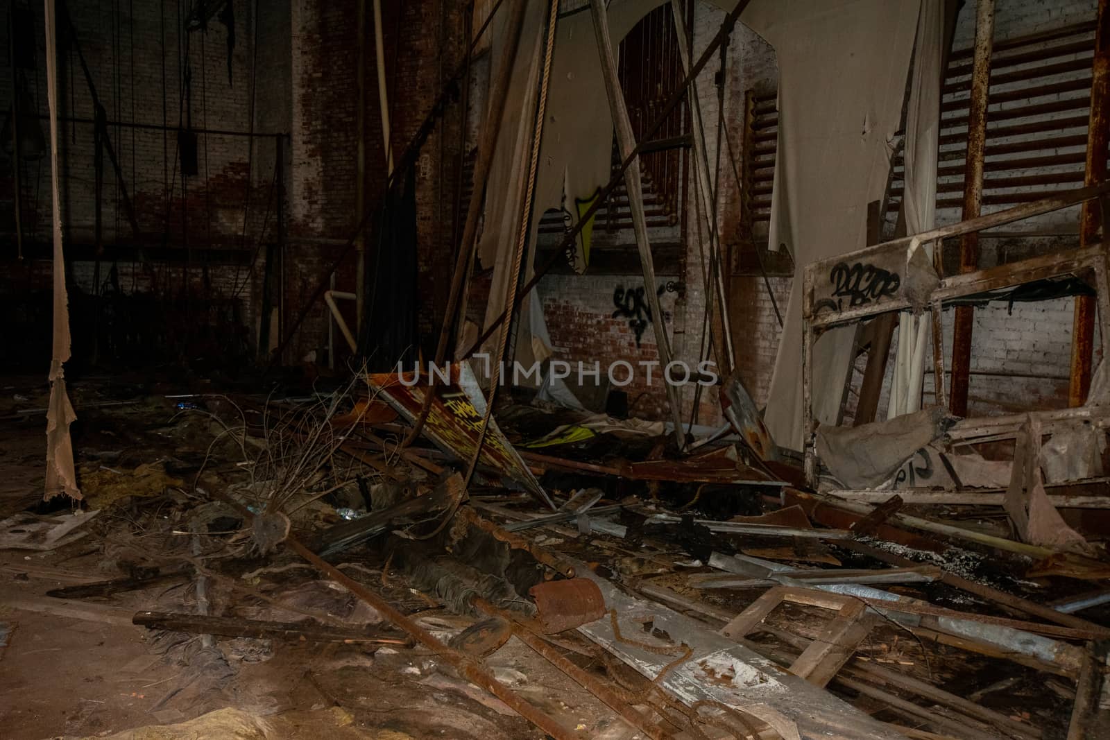 A Stage in an Abandoned Theatre Covered in Trash and Debris by bju12290