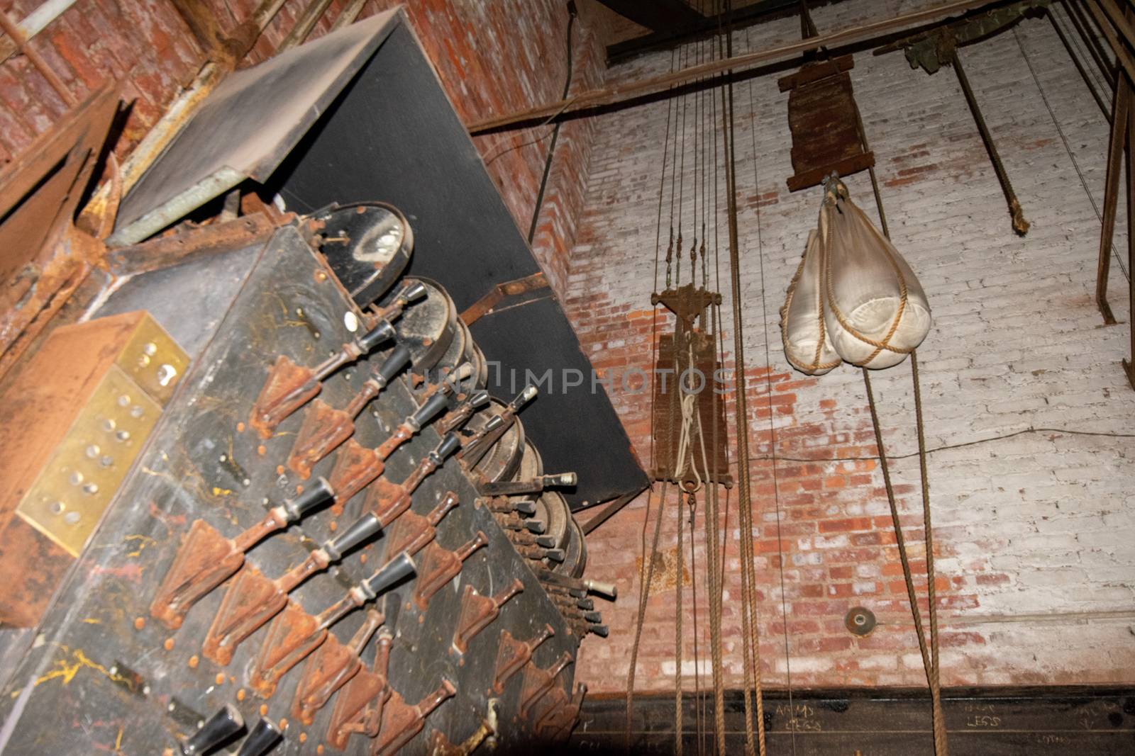 An Old Fashioned Switch Board Full of Rusty Levers With Black Handles on the Stage of an Abandoned Theatre