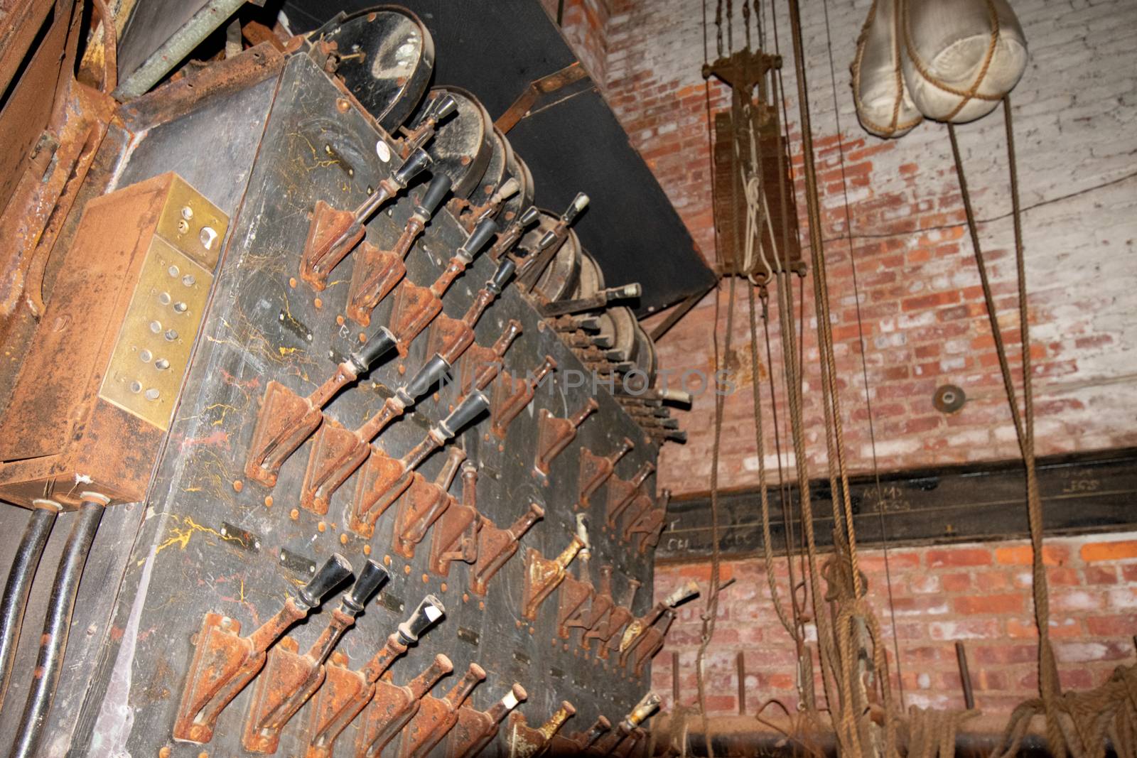 An Old Fashioned Switch Board Full of Rusty Levers With Black Handles on the Stage of an Abandoned Theatre