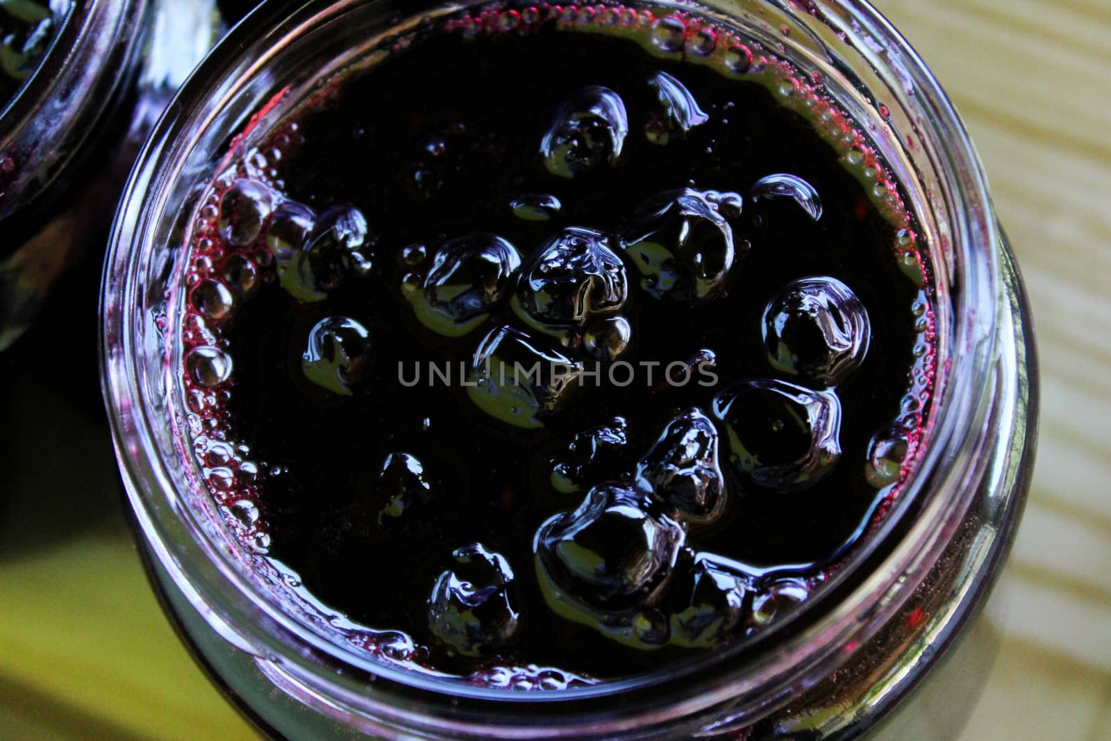 Homemade chokeberry jam. The process of filling jars in a homely way. Zavidovici, Bosnia and Herzegovina.