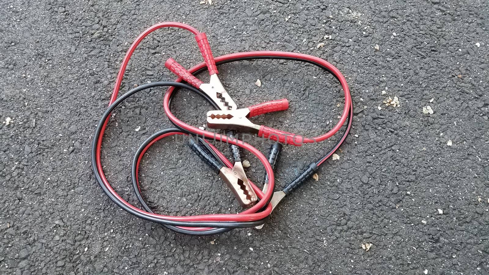 red and black jumper cables on ground by stockphotofan1