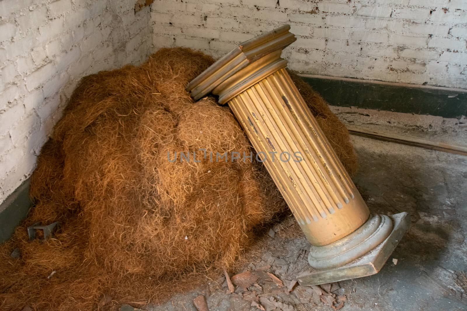 A Column Leaning on a Pile of Hay Used as Props During a Play in by bju12290