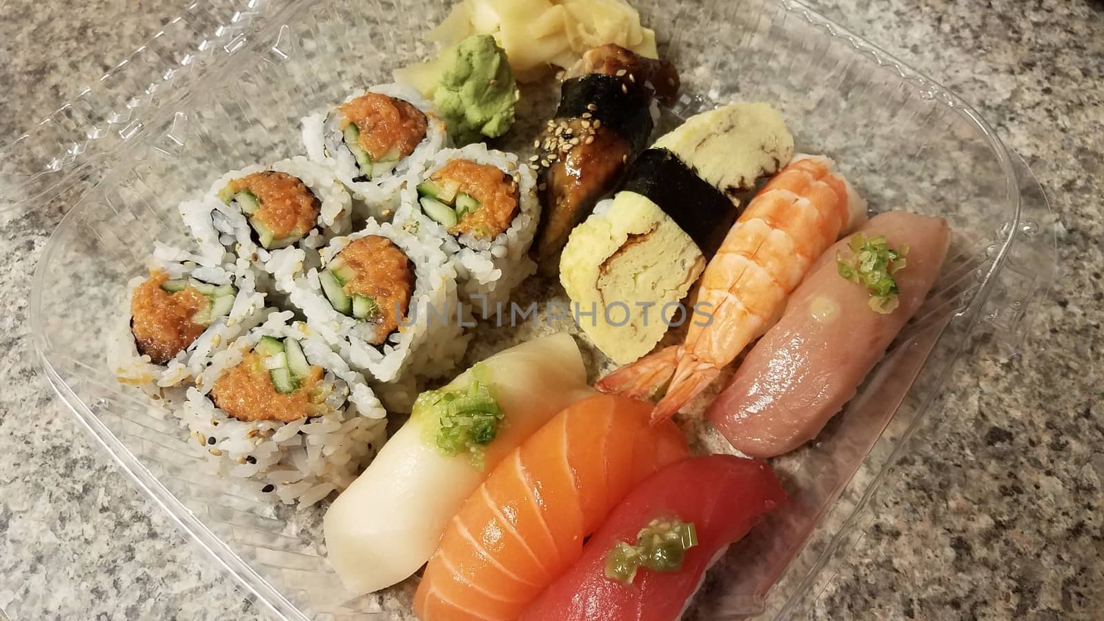 salmon and tuna and rice sushi in plastic container by stockphotofan1