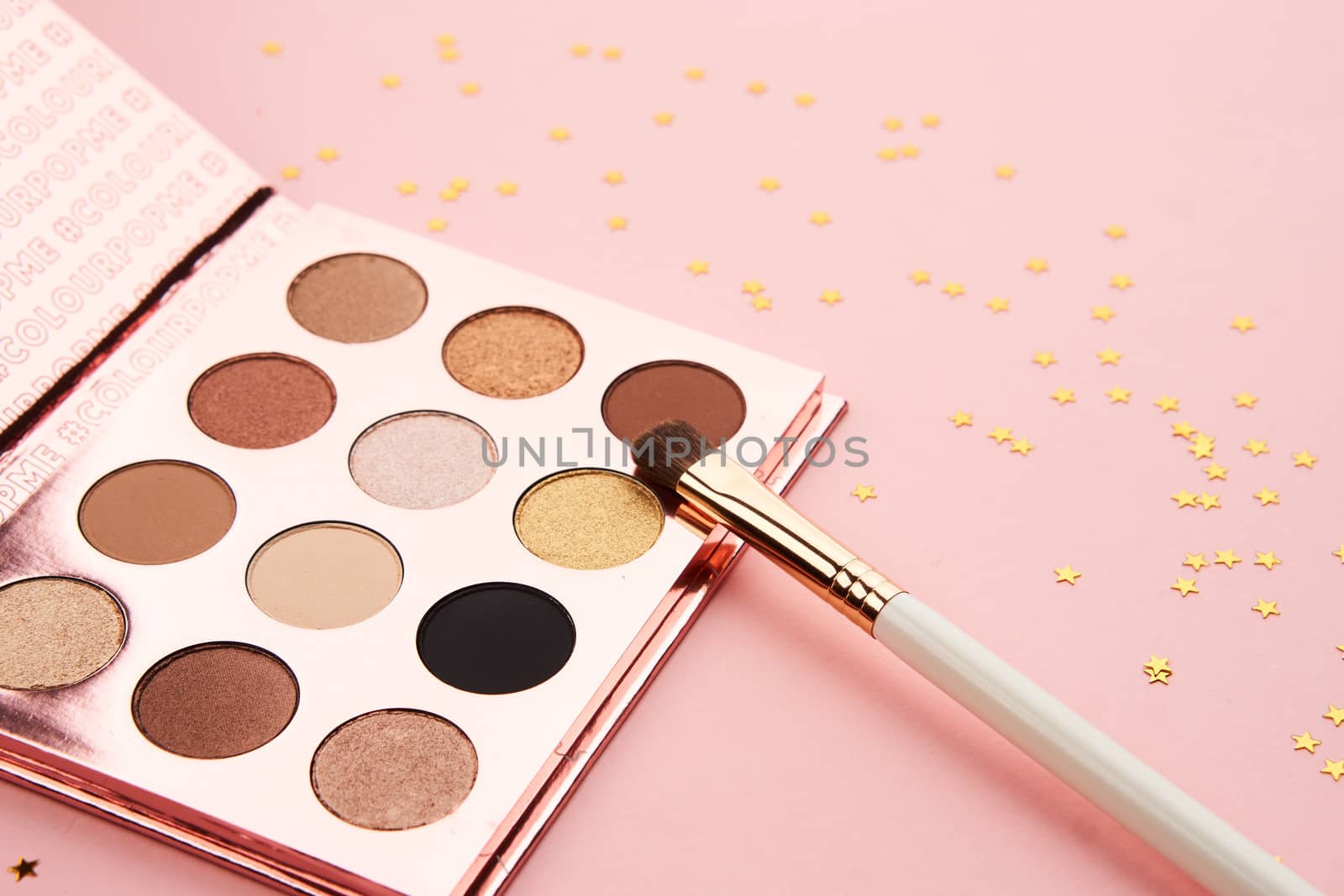 eyeshadow accessories beads makeup brushes collection professional cosmetics on pink background. High quality photo