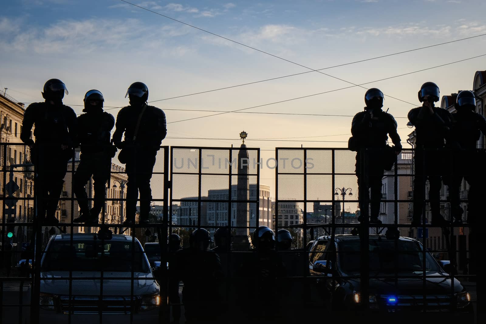 Riot police blocking the road for protesters. The army is blocking the city. Silhouettes of soldiers