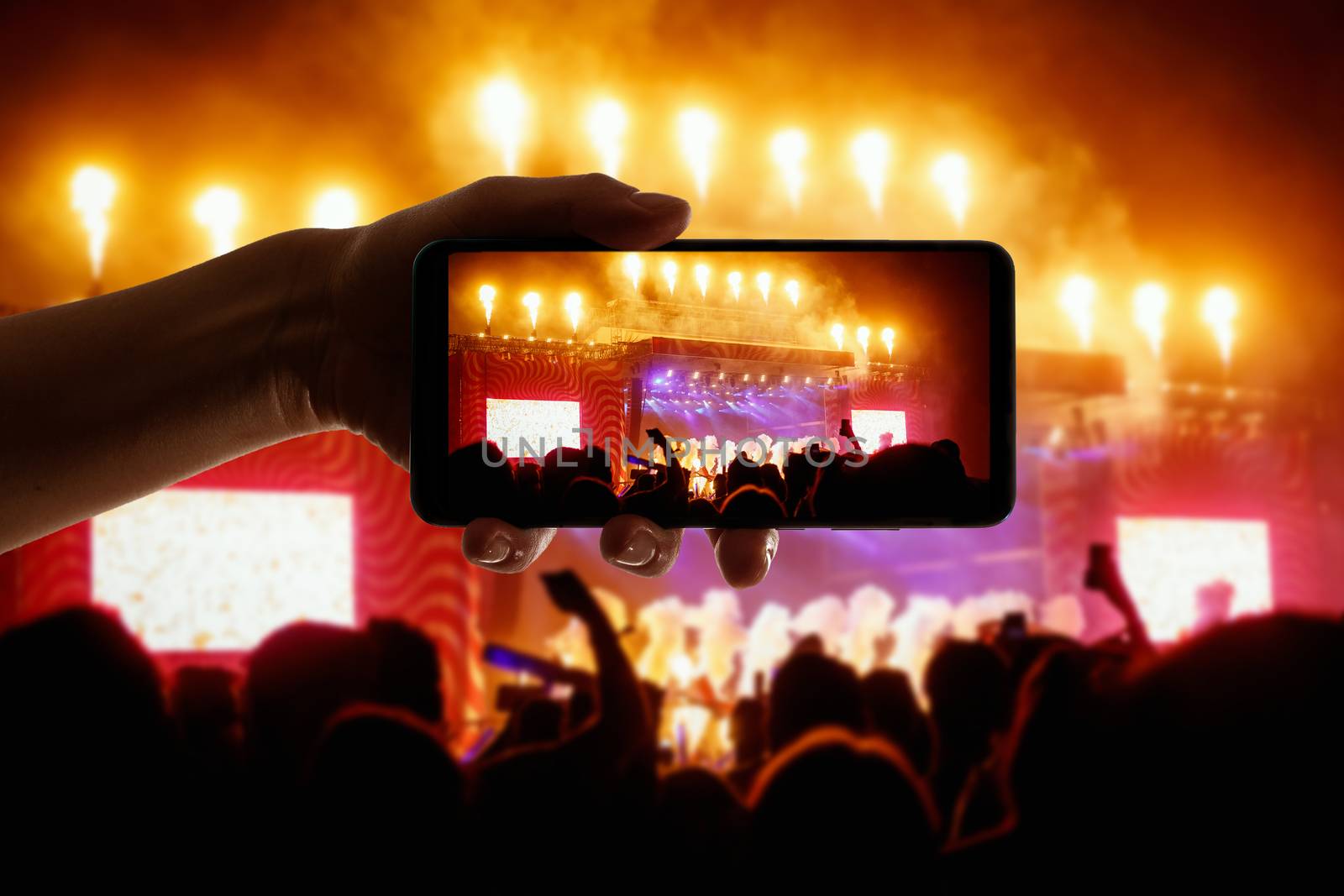 Big concert stage with fire production at outdoor music festival