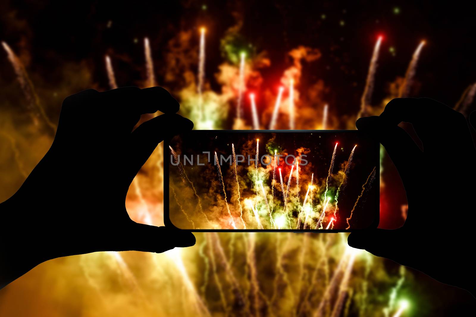 Taking the photo of fireworks via smartphone. Broadcast salute video to the internet. by 9parusnikov