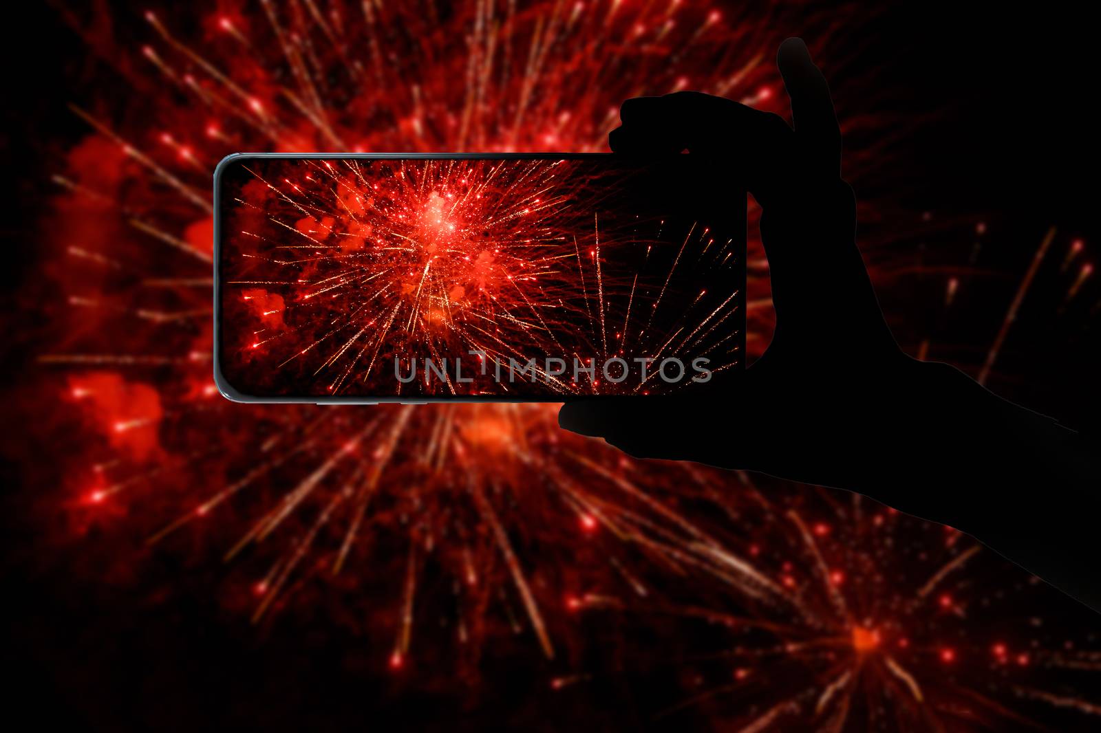 Taking the photo of fireworks via smartphone. Broadcast salute video to the internet. by 9parusnikov