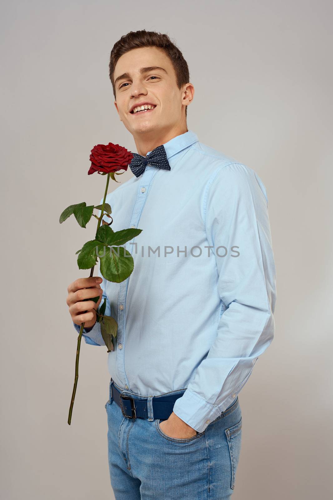 romantic man with red rose and light shirt pants suit by SHOTPRIME