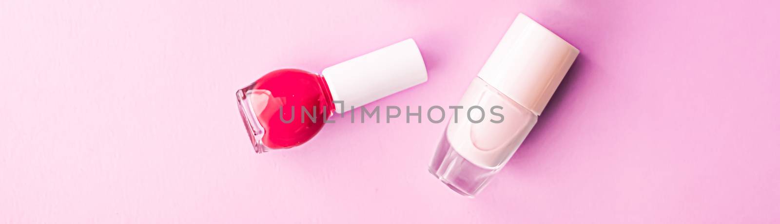 Nail polish bottles on pink background, beauty brand by Anneleven