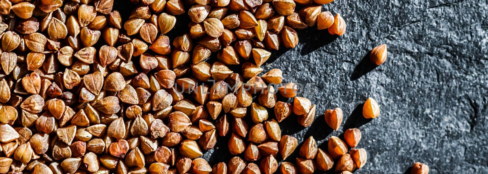 Buckwheat grain closeup, food texture and cook book background by Anneleven