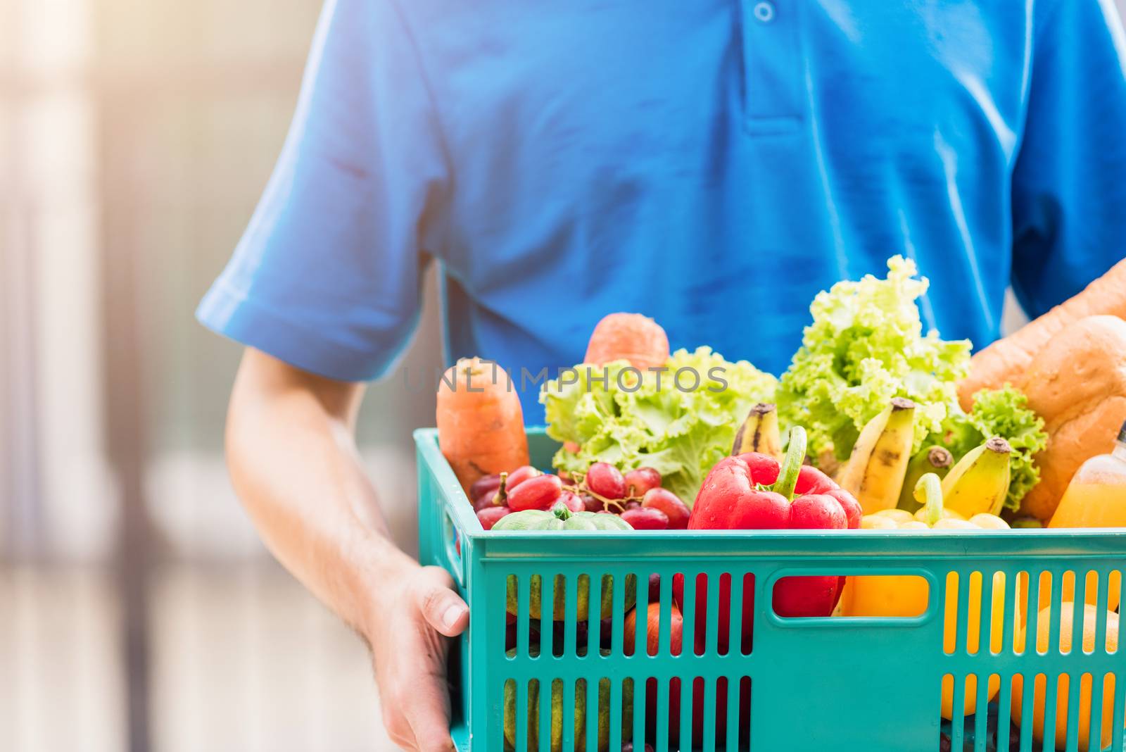 Delivery man wearing face mask protect he delivering fresh food  by Sorapop