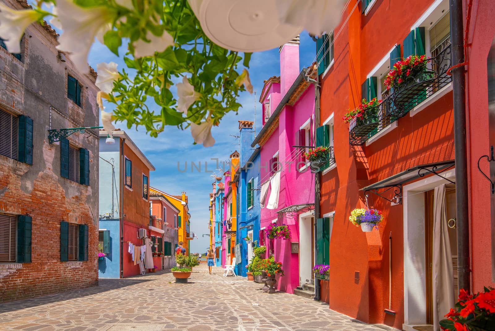 Colorful houses in downtown Burano, Venice, Italy with clear blue sky