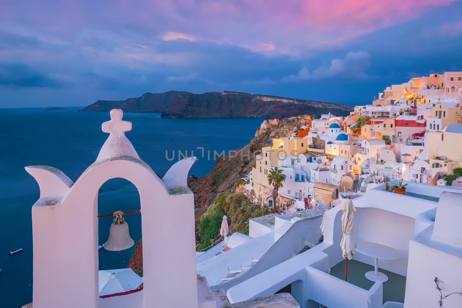 Oia town cityscape at Santorini island in Greece at sunset. Aegean sea