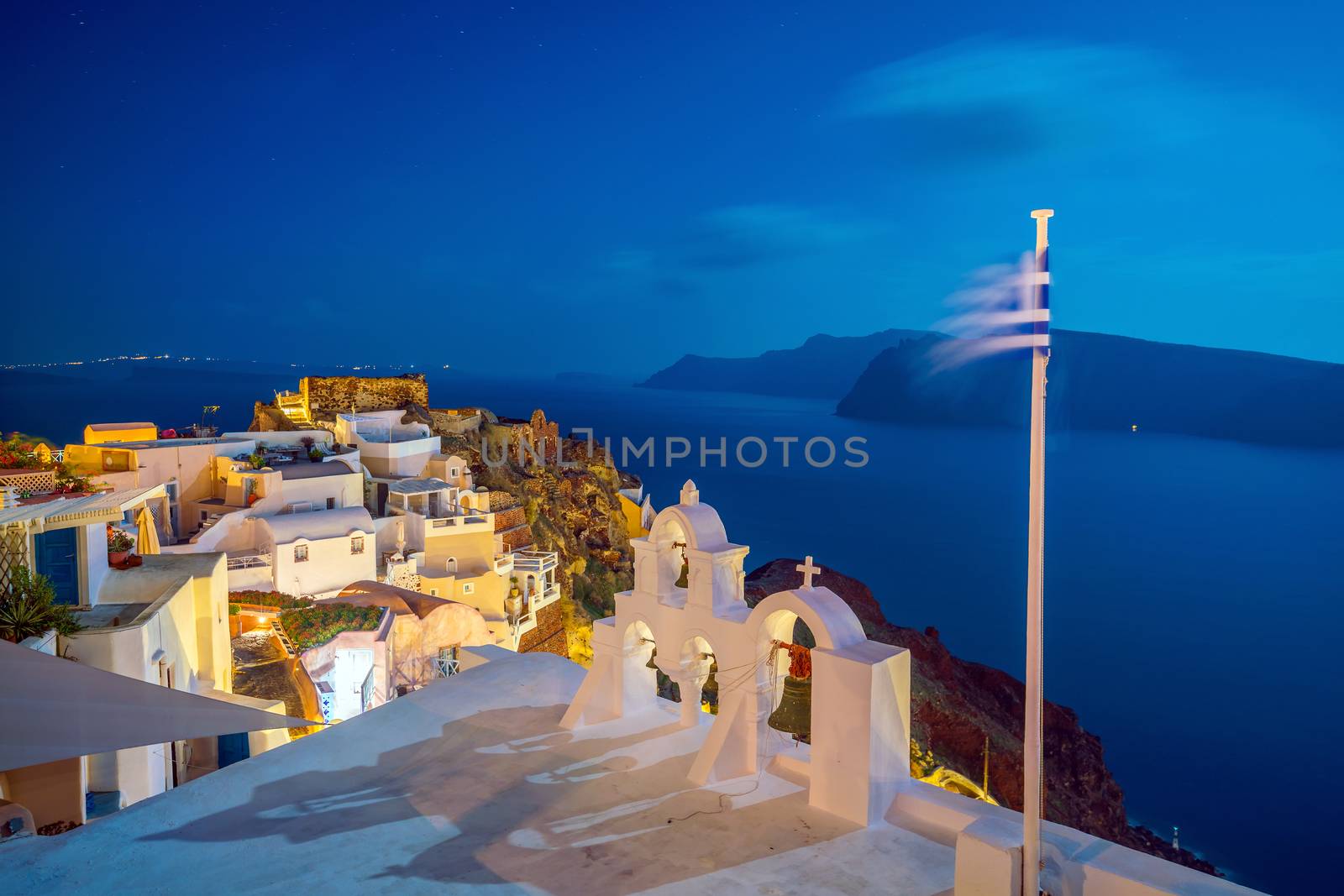 Oia town cityscape at Santorini island in Greece at sunset. Aegean sea