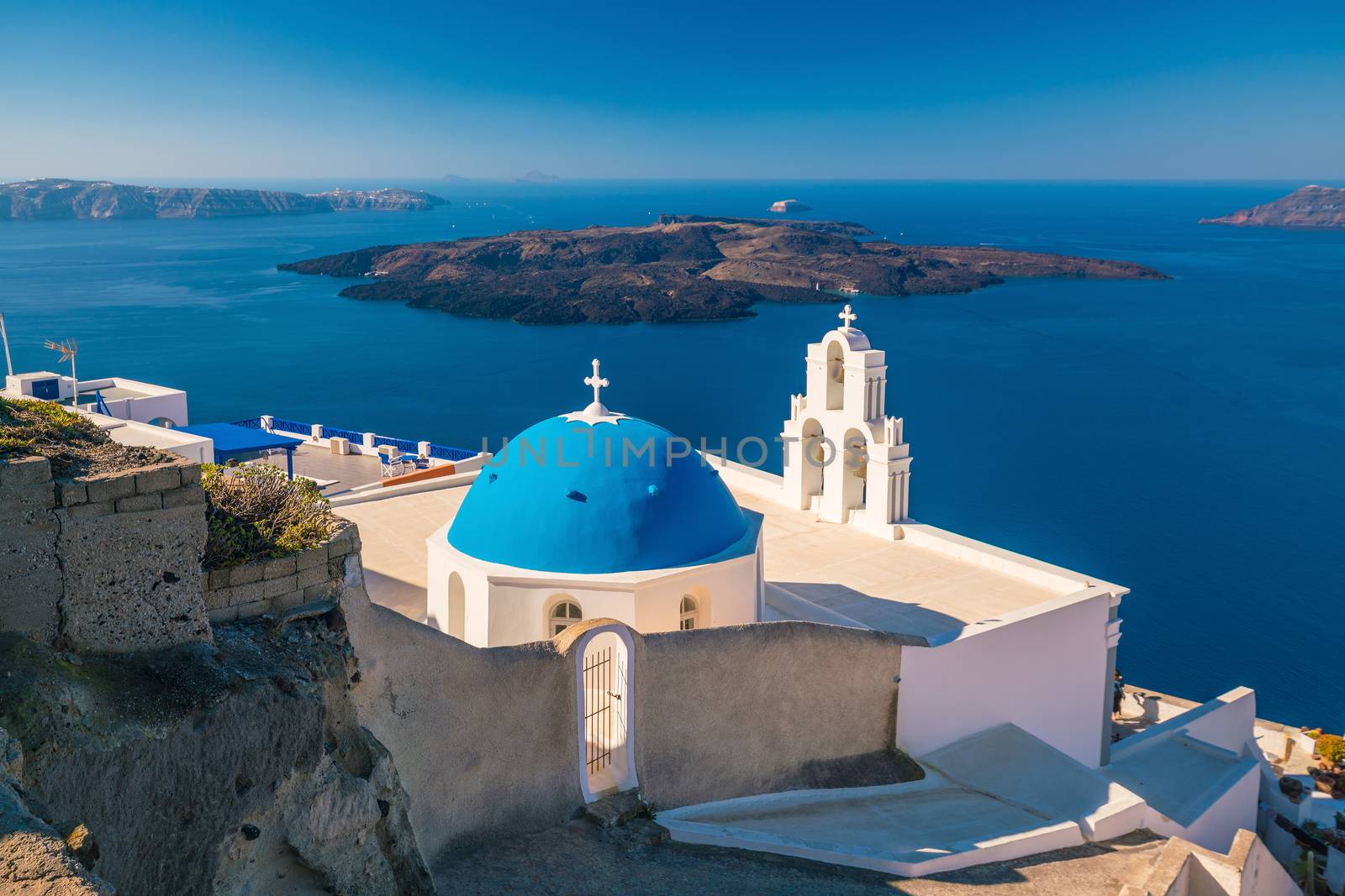 Three Bells of Fira in Santorini, Greece with blue sky