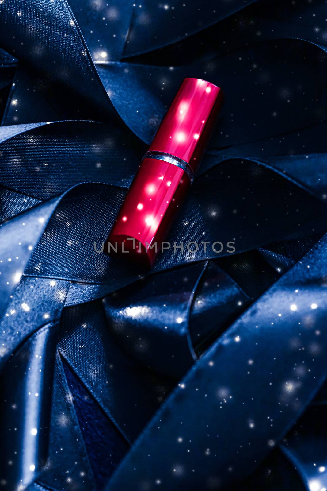 Red lipstick on blue silk and shiny glitter background, luxury make-up and beauty cosmetics