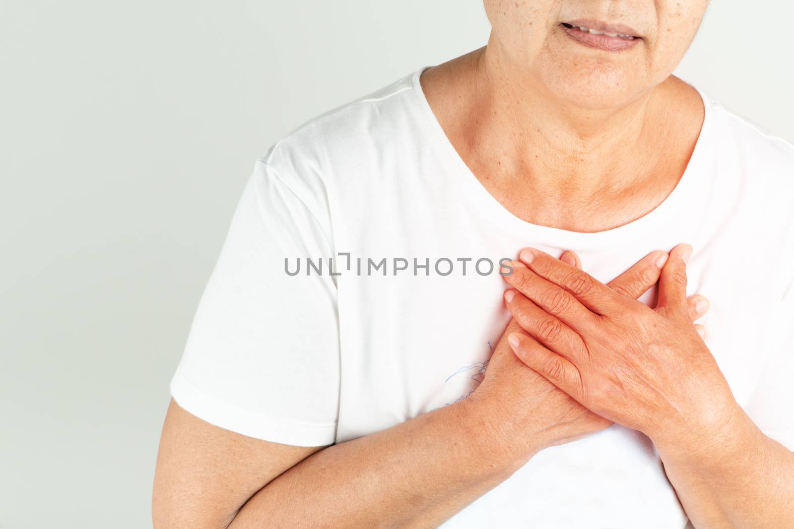Old woman heart attack holding breast on white background