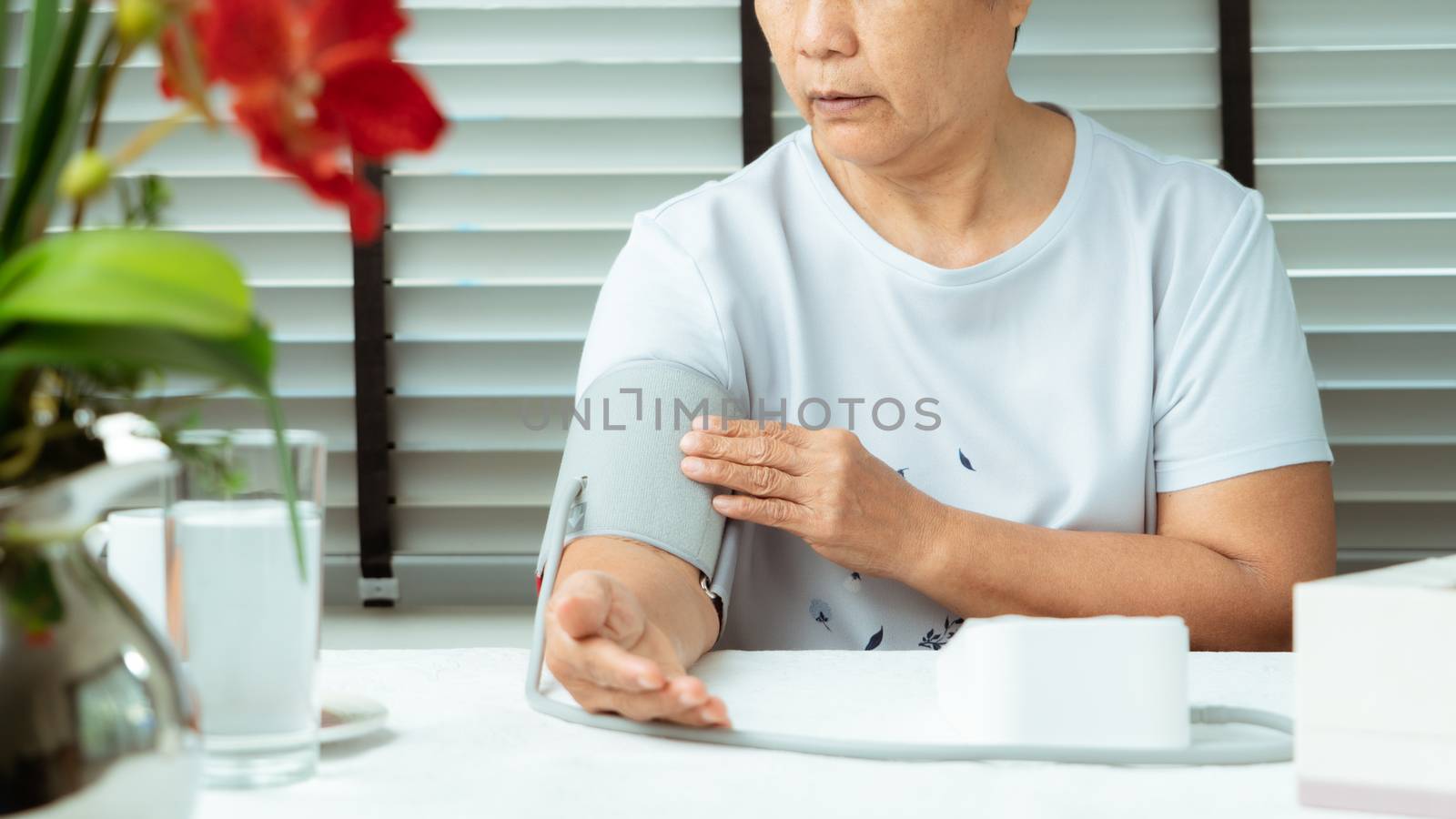 senior woman is detecting blood pressure at home