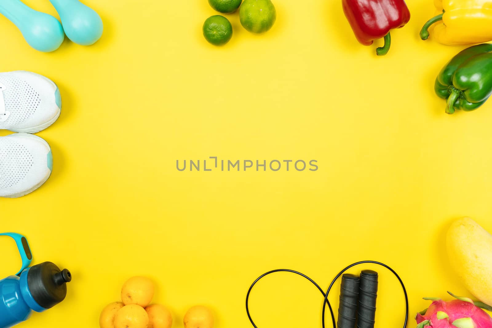 Healthy lifestyle, food and sport concept. athlete's equipment and fresh fruit and vegetable on yellow background.