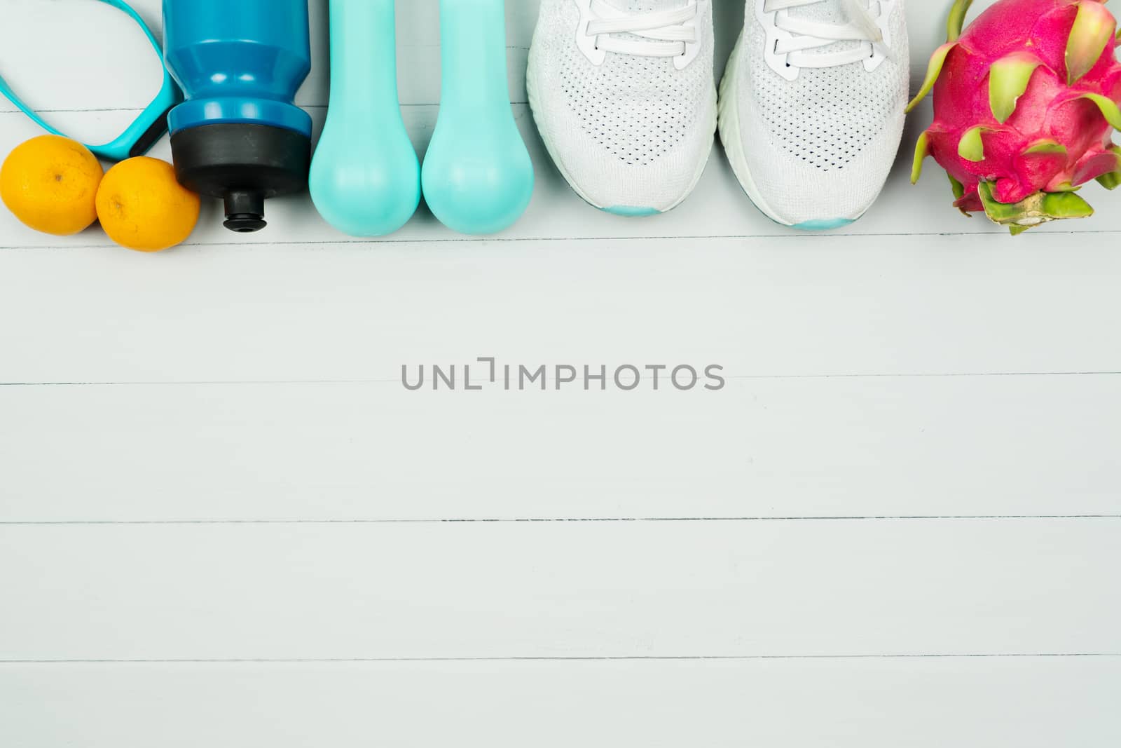 Healthy lifestyle, food and sport concept. athlete's equipment and fresh fruit on wooden background.