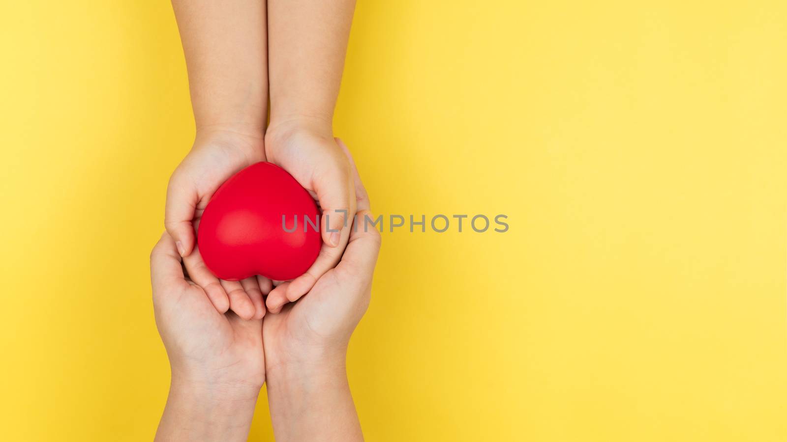 world health day, adult and child hands holding red heart, healt by psodaz